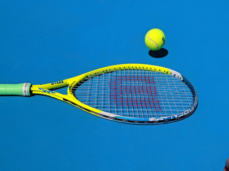 Tennis racket and ball on a court at KPLTC